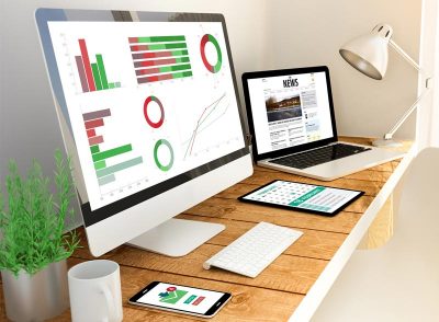 Office desk with computer screen showing data